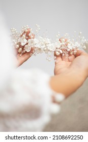 bride hands hold wedding hair accesory with white flowers. jewelry for bride. headpiece for bride. tiara