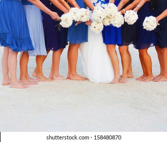 A bride and her bridesmaids holding flowers at beach in Key West Florida