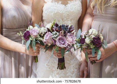 bride with her bridesmaids holding wedding bouquets - Shutterstock ID 757828678
