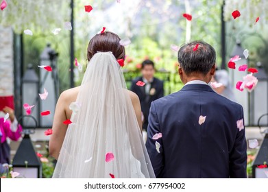 A Bride And Her Father's Walking Down The Aisle