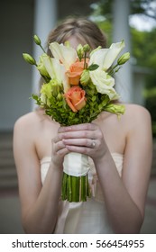 Bride Hiding Face Behind Bouquet