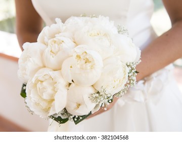 A Bride Is Holding A Bouquet