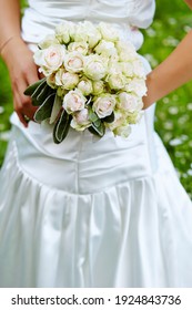 Bride Holding Bouquet Of Flowers