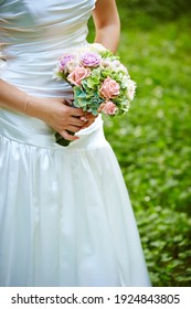 Bride Holding Bouquet Of Flowers