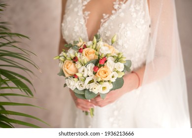 Bride Holding Bouquet Of Flowers