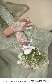 A Bride Holding A Flower Bucket With Beautiful Artwork White Henna In Her Hands