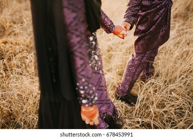 Bride Holding Groom's Hand With Mehndi/henna Tattoo.