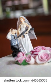 Bride Holding Gun To Groom Funny Wedding Cake Topper With Pink Roses Closeup