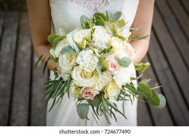 Bride holding her wedding flowers - Shutterstock ID 724677490