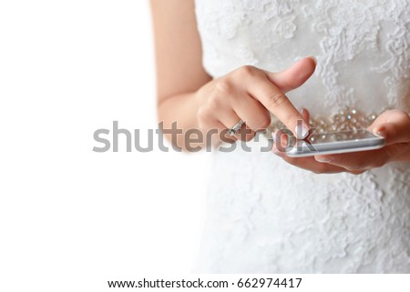 Bride holding modern phone and touching screen, isolated on white background with free space