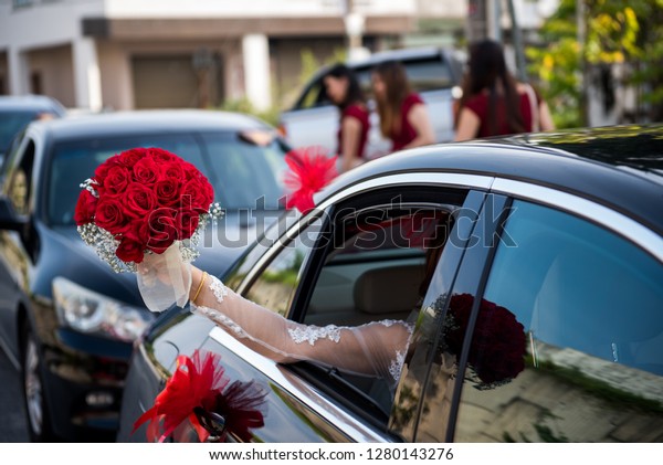 Bride\
Holding a Wedding Bouquet in the wedding\
car