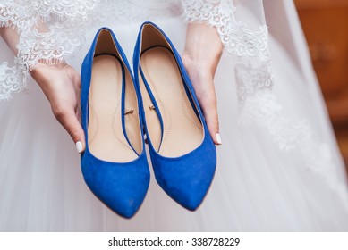 Bride Holding Wedding Shoes Blue