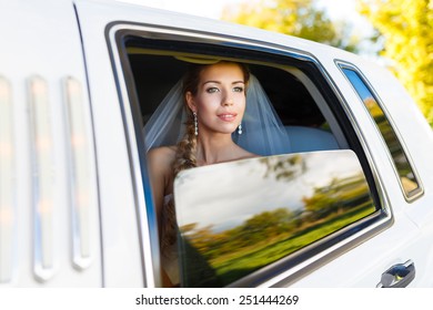 Bride Looks Out Of The Window A White Limousine