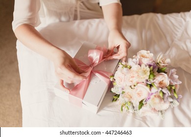 Bride Opening Her Present Box With Pink Ribbon. Romantic Surprise For Girl. Happy Birthday. Wedding Gift