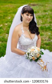 Bride in a park. wedding dress. Bridal wedding bouquet of flowers