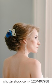 Bride posing by the window