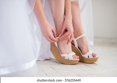 Bride puts White shoes for wedding