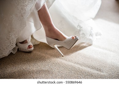 Bride Putting On Wedding Shoes