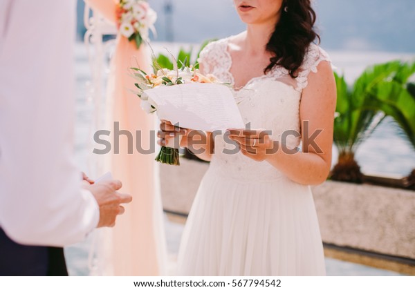 bride reading\
wedding vows. Wedding\
ceremony