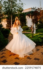 the bride runs through the garden at sunset. beautiful wedding clothes. selection of a picturesque place for the ceremony. - Shutterstock ID 2259174875