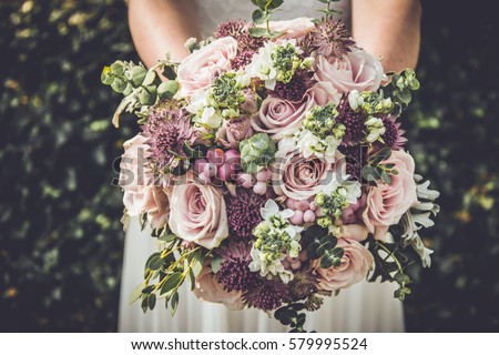 Bride showing off her beautiful boho flowers bouquet.
Perfect image with copy space for: chic boho wedding magazines and websites, bohemian, fashion, florist and other related subjects. 