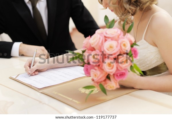 Bride\
signing marriage license or wedding\
contract