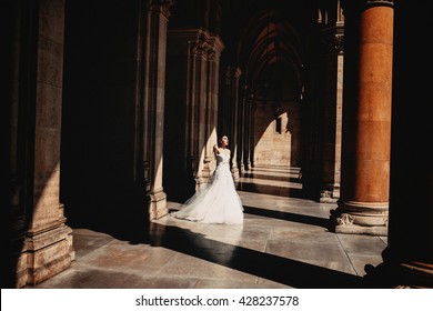 Bride standing  between coloums