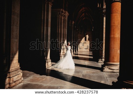 Bride standing  between coloums