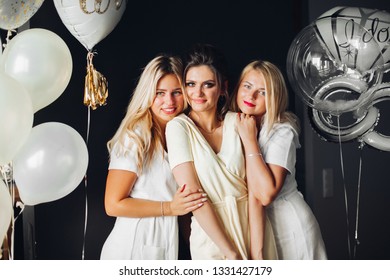 Bride Standing With Sad Bridesmaids And Showing Wedding Rind