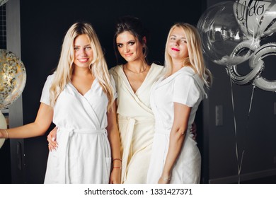 Bride Standing With Sad Bridesmaids And Showing Wedding Rind