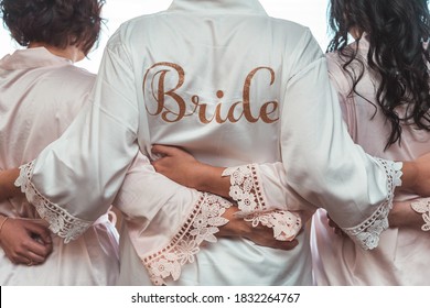 A Bride Stands By Her Bridemaids While Getting Ready For Her Wedding Day - Powered by Shutterstock