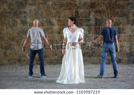 Similar – Woman in wedding dress with two men on a rope