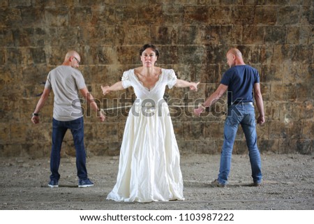 Similar – Woman in wedding dress with two men on a rope