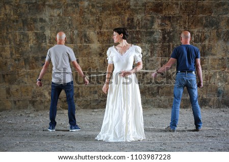 Similar – Woman in wedding dress with two men on a rope