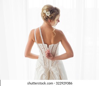 Bride Unzipping Her Dress