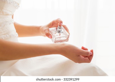 Bride using perfume 
