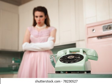 Bride waits by the phone in a retro-style kitchen scene