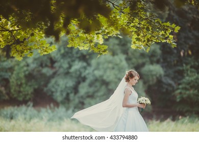 Bride Walking On Soft Green Park