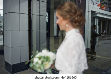 Bride Walks To A Groom Who Repeats His Wedding Speech Standing In The Front Of A Hotel Entrance