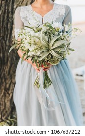 Bride Wearing Light Blue Wedding Dress Holding Big Bouquet