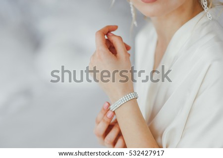 the bride wears a bracelet on hand