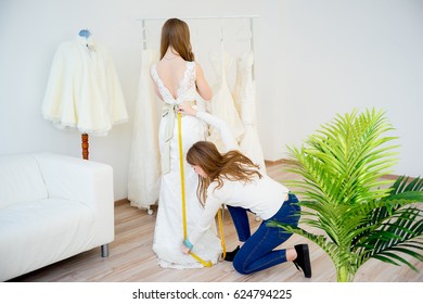 Bride with wedding assistant