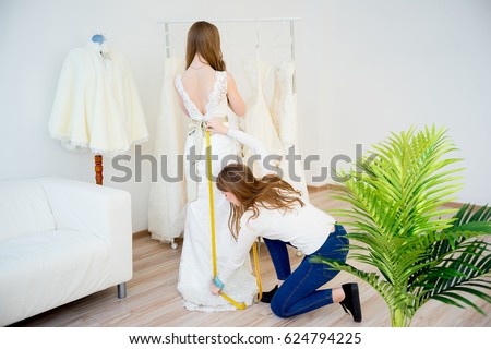 Bride with wedding assistant