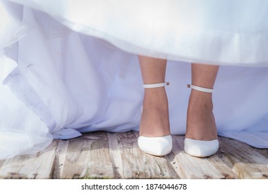 Bride in Wedding Shoes and Dress