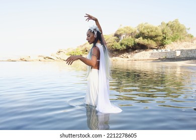 The Bride In A White Cloak, Walking In The Water, Dances Towards The Sky. A Scene From The Pagan Ceremony.