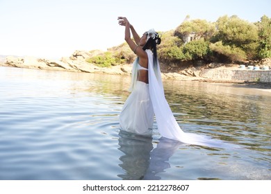 The Bride In A White Cloak, Walking In The Water, Dances Towards The Sky. A Scene From The Pagan Ceremony.