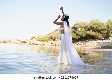 The Bride In A White Cloak, Walking In The Water, Dances Towards The Sky. A Scene From The Pagan Ceremony.