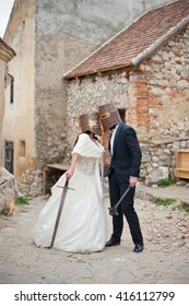 bride in a white dress with a sword fight with her ??groom who has a mace