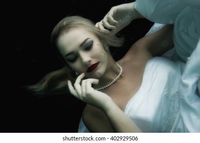 Bride In White Underwater With Pearl Necklace