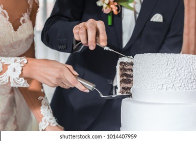 Brides cut wedding cake.